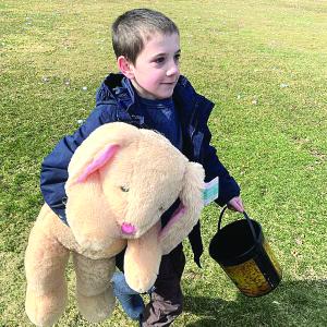 Wiscasset’s Sam Renzi, 8, returns to his family after winning a stuffed bunny at the Easter egg hunt March 30 at the Wiscasset Middle High School track. SUSAN JOHNS/Wiscasset Newspaper 