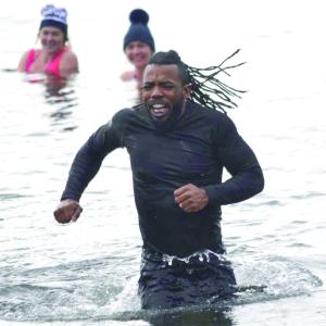 One of the participants in the Penguin Plunge can't leave the water fast enough. KEVIN BURNHAM/Boothbay Register