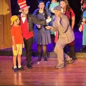 Horton (Soren Barker) gently receives the spec containing Whoville from the Cat in the Hat (Nick Mirabile) with Jojo (Gannon Inman) watching. Grinch (Roosevelt Bishop) antics.   LISA KRISTOFF/Boothbay Register