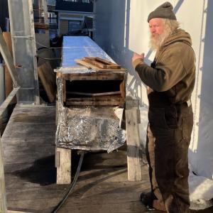 Tom Gerhard shows off a steam box used to make wooden planking pliable enough to put on the ship. FRITZ FREUDENBERGER/Boothbay Register