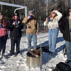 Lincoln Academy students enjoy the hot cocoa they prepared after building a fire. Courtesy of Shannon Parker Lincoln Academy students enjoy the hot cocoa they prepared after building a fire. Courtesy of Shannon Parker