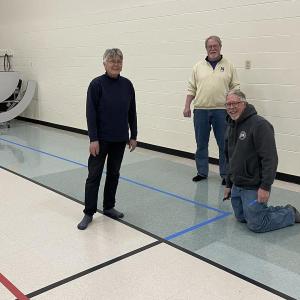From left, Susan Hartford, Kipp Bacon and Randy Finamore (kneeling) help with a pickleball unit at Dresden Elementary School. Peter Walsh photo 