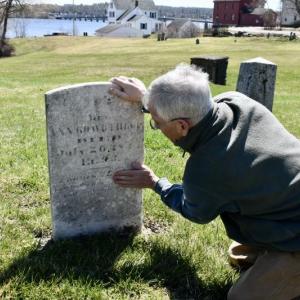 Steve Christiansen examines the headstone of Ezekiel Averill remembered for having served as a body guard to George Washington during the American Revolution. PHIL DI VECE/Wiscasset Newspaper