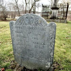 Dated 1739, the headstone of Joshua Pool is the oldest one in the Ancient Cemetery. According to the legend, Pool drowned in the Sheepscot River when an enraged black capsized his canoe. In the background can be seen the Chief Justice Samuel Smith memorial. PHIL DI VECE/Wiscasset Newspaper