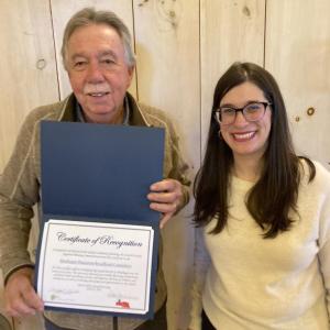 Bill Boynton, member of the Monhegan Broadband Committee and Emily Rabbe, Executive Director of LCRPC, displaying the award Monhegan's Broadband Committee received for their community planning efforts. Courtesy of LCRPC Bill Boynton, member of the Monhegan Broadband Committee and Emily Rabbe, Executive Director of LCRPC, displaying the award Monhegan's Broadband Committee received for their community planning efforts. Courtesy of LCRPC