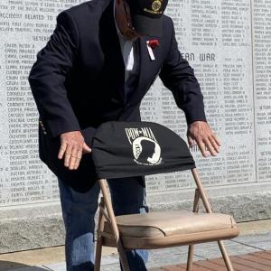 Wiscasset’s Rupert Flood adds the POW/MIA cloth to the empty chair representing those still unaccounted for. SUSAN JOHNS/Wiscasset Newspaper Memorial Day