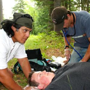 First Aid volunteers assess a patient in a wilderness setting. Courtesy of Wilderness Medical Associates International First aid