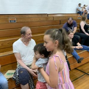 Kinsley Waite, 8, carries cousin Levi Daly, 2, in Wiscasset Middle High School’s Stover Auditorium June 5, before Waite’s big brother Dominic Waite graduated. SUSAN JOHNS/Wiscasset Newspaper Graduation