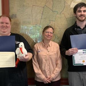 Lincoln County 911 dispatchers Craig Balsdon, left, and Richard Hasch, right, received a pin, certificate and gift June 3 for assisting callers in an emergency. Also pictured, Communications Director Tara Doe. BILL PEARSON/Boothbay Register Heroes