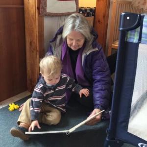 Ethel Stansfield reads to a child. Audrey Latella/Sheepscot Valley Children’s House photo 
