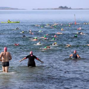 Swimmers plunge into the water at the start of the 2024 Pemaquid Beach Triathlon. Kris Christine photo