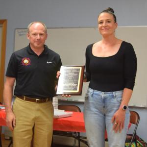 Waldoboro Fire Chief Paul Smeltzer presents Hannah Meneses with the Citizens Life Saving Award during the Lincoln County Fire Chiefs Association’s annual meeting on Wednesday, Aug. 20 in South Bristol. Meneses received the award for her actions on March 28 when she exhibited exceptional courage and quick thinking to save a man trapped in a sinking vehicle in Davis Stream in Jefferson. Christina Wallace photo Meneses