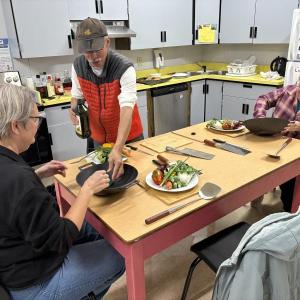  Chris Toy demonstrates how to season a new wok in the fall session of Wok & Cleaver Boot Camp. Courtesy photo 