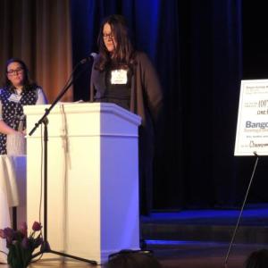 Brynne Whitney speaks to 100+ Women Who Care members about Bangor Savings Bank's support. Courtesy photo