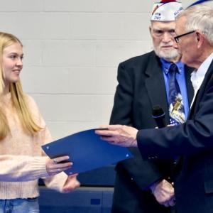 Olivia Drewniak, a senior at Morse High School was recognized at Woolwich's annual town meeting and shown here accepting a certificate recognizing her accomplishment from David King Sr. select board chairman. PHIL DIVECE/Wiscasset Newspaper 