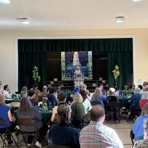 CTL's founder Nancie Atwell speaks to a crowd of alumni and current families in the school's auditorium. Courtesy photo