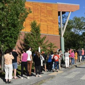 At one point the line of voters waiting to get into the town meeting at the Woolwich Central School stretched outside the building. PHIL DI VECE/Wiscasset Newspaper