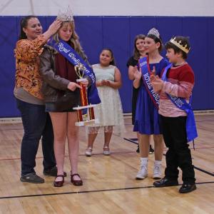 Emily Mirabile places the Royal Windjammer crown on Violet Baldwin's head. STEVE EDWARDS/Boothbay Register
