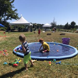 Children enjoying the splash pad at Field & Forest Family Fun Day. This free community event will take place on July 18 at Oak Point Farm. Courtesy of BRLT