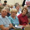 Ira and Connie Machon, along with Sharon Barter, listen to the discussion at the meeting.